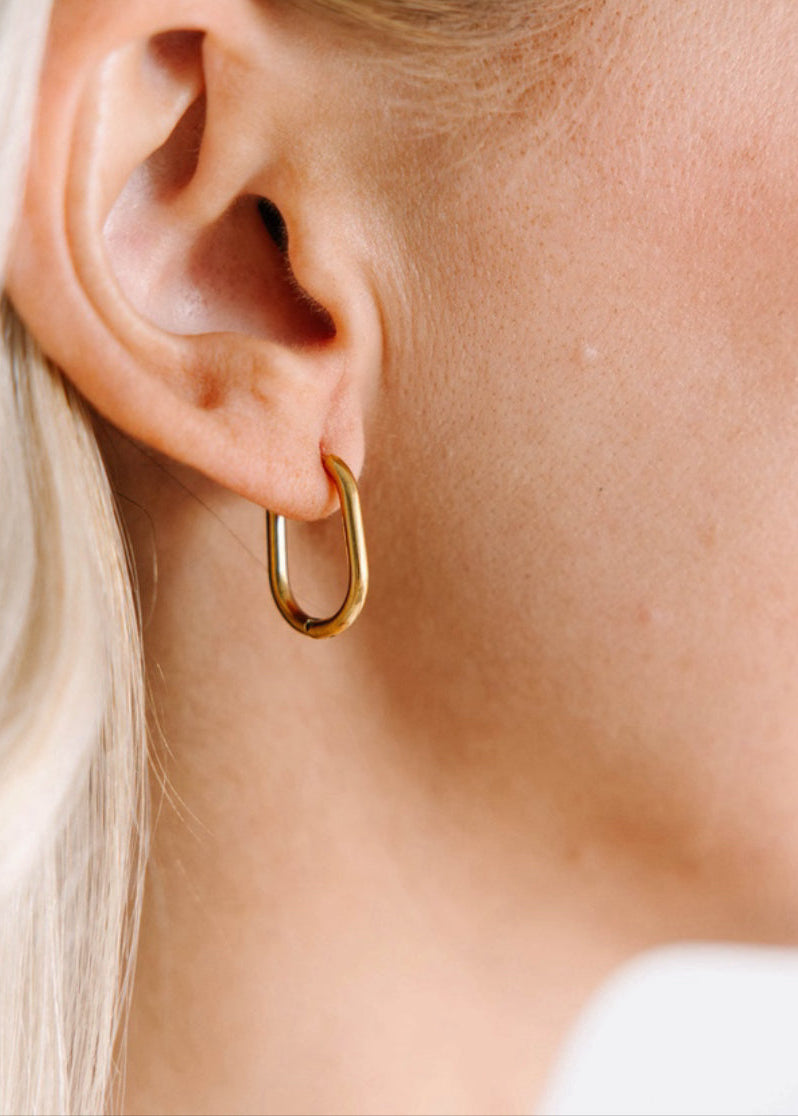 Rectangle Gold Huggies in the ear