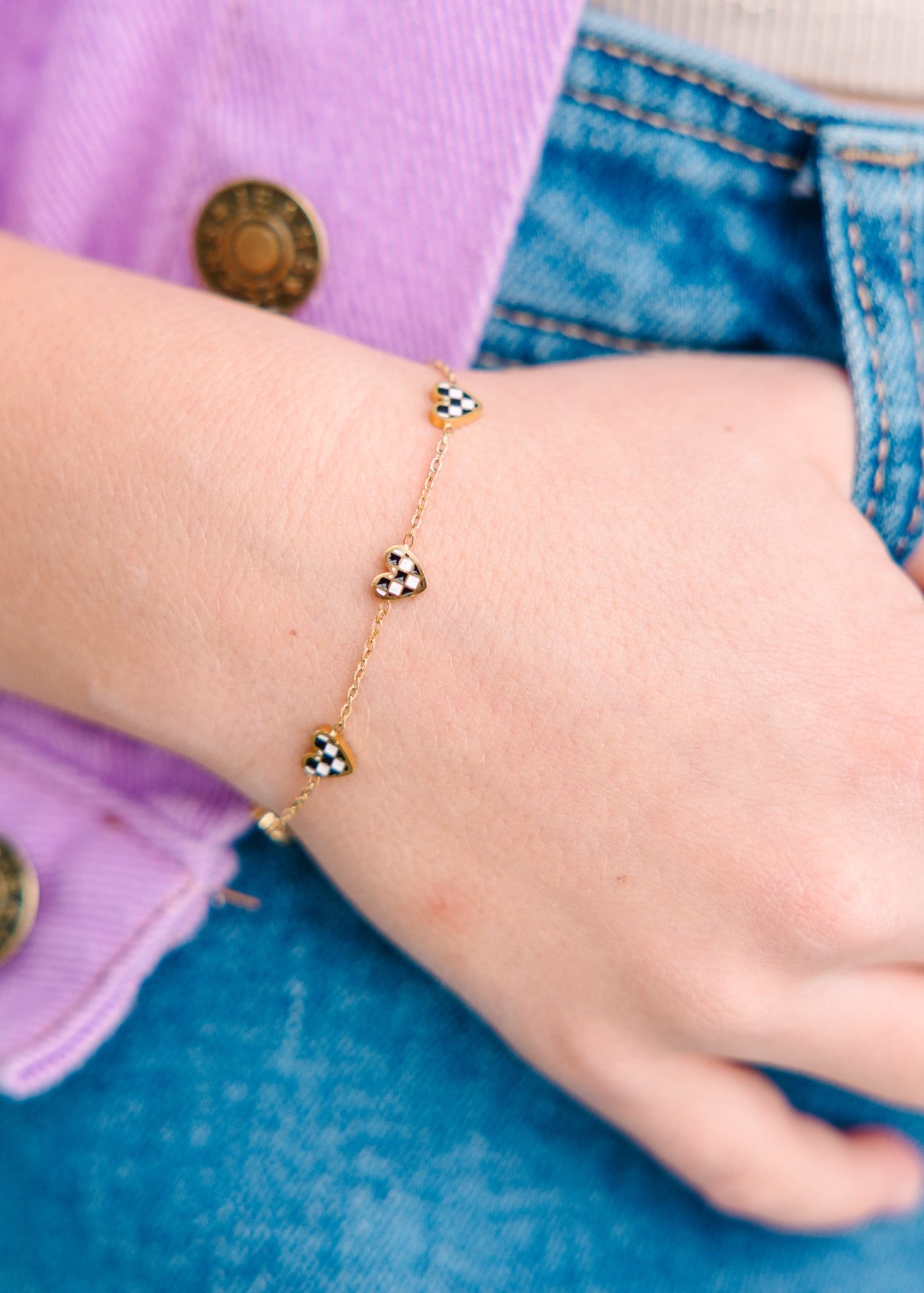 Black & White Checkered Heart Bracelet on a person's wrist