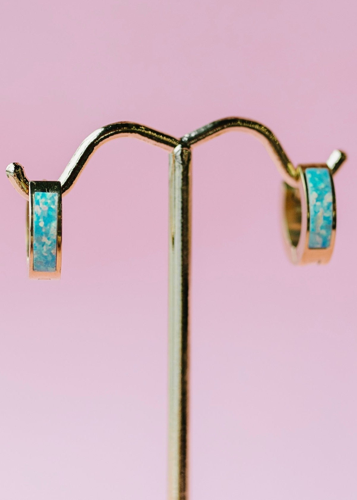 Ocean blue opal huggies on gold stand